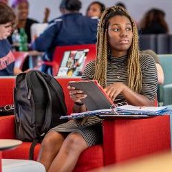 Student in lounge using tablet